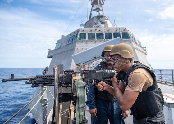 SOUTH CHINA SEA (Feb. 7, 2022) Chief Gunner's Mate Darius Sullivan, left, from Laurel, Mississippi, and Aviation Machinist's Mate 3nd Class Jordan Jackson, from Mesa, Arizona, assigned to the “Blackjacks” of Helicopter Sea Combat Squadron (HSC) 21, participates in a live fire gunnery exercise using a M240B machine gun aboard Independence-variant littoral combat ship USS Charleston (LCS 18). Charleston, part of Destroyer Squadron (DESRON) 7, is on a rotational deployment in the U.S. 7th Fleet area of operation to enhance interoperability with partners and serve as a ready-response force in support of a free and open Indo-Pacific region. (U.S. Navy photo by Mass Communication Specialist 2nd Class Ryan M. Breeden)