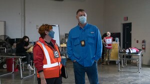 Sancic and Mays stand in open bay area used during the exercise where simulated patients were brought in to be processed.