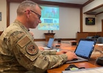 Command Chief of Air Education and Training Command U.S. Air Force Chief Master Sgt. Erik Thompson types on a laptop