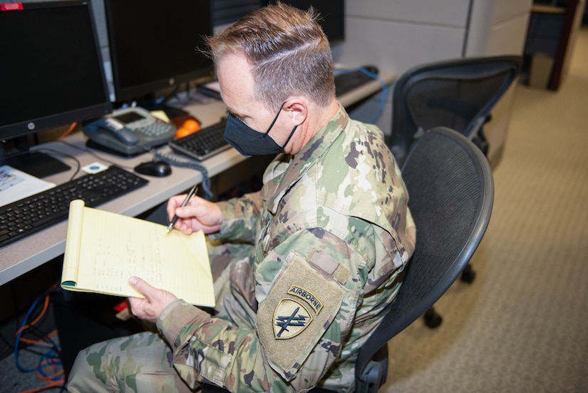 Government Functional Specialty Team, 351st Civil Affairs Command, U.S. Army Civil Affairs and Psychological Operations Command (Airborne), looks over his notes prior to a briefing during Keen Edge 22, Camp Smith, Hawaii.