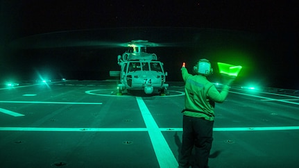 SOUTH CHINA SEA (Jan. 24, 2022) Aviation Structural Mechanic 1st Class Cari McPheeters, from Milwaukie, Oregon, signals an MH-60S Sea Hawk helicopter, assigned to the “Blackjacks” of Helicopter Sea Combat Squadron (HSC) 21, during flight operations aboard Independence-variant littoral combat ship USS Charleston (LCS 18). Charleston, part of Destroyer Squadron (DESRON) 7, is on a rotational deployment in the U.S. 7th Fleet area of operation to enhance interoperability with partners and serve as a ready-response force in support of a free and open Indo-Pacific region. (U.S. Navy photo by Mass Communication Specialist 2nd Class Ryan M. Breeden)