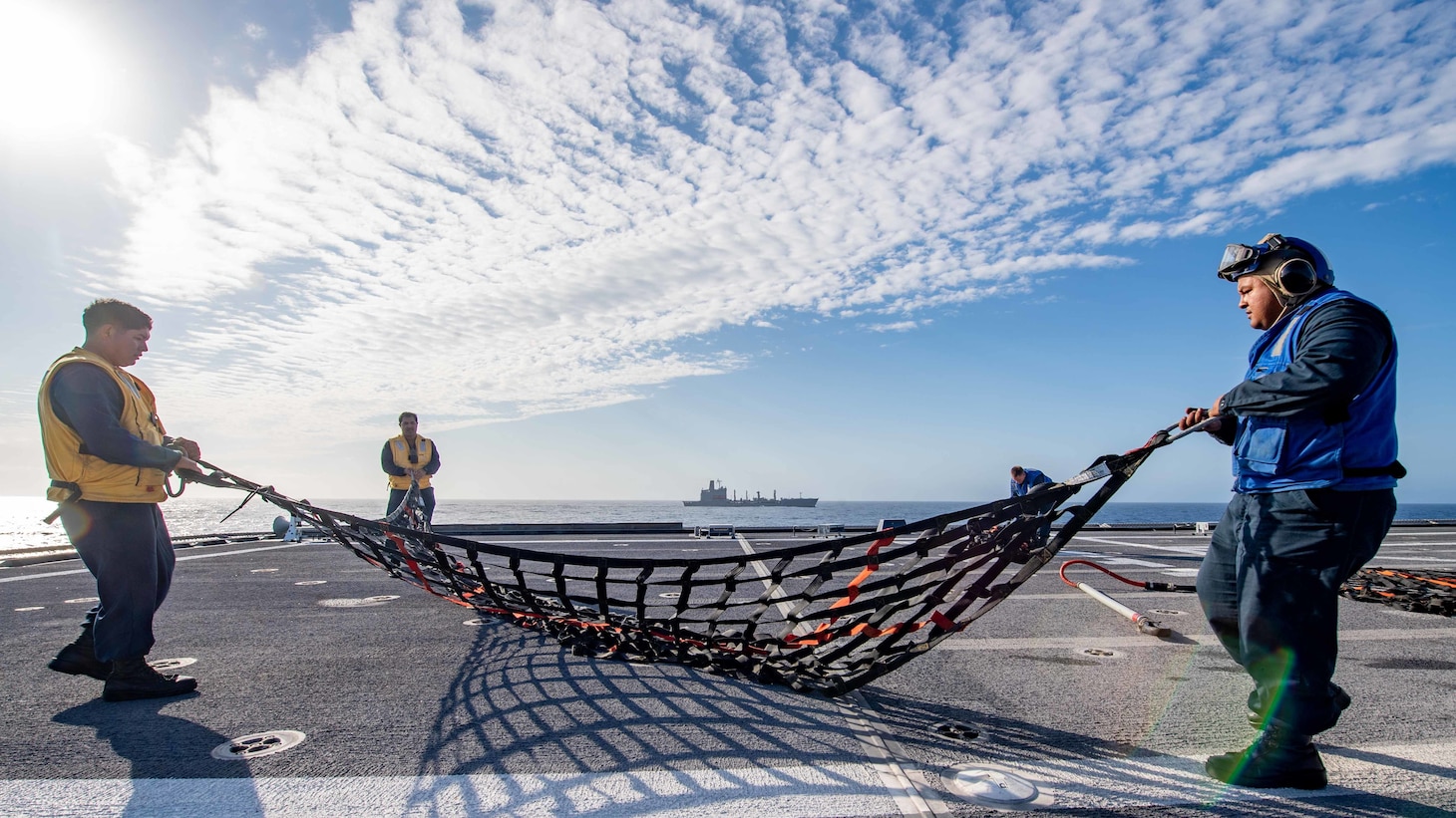 SOUTH CHINA SEA (Feb. 2, 2022) Sailors prepare for a vertical replenishment with fleet replenishment oiler USNS Guadalupe (T-AO 200) aboard Independence-variant littoral combat ship USS Charleston (LCS 18). Charleston, part of Destroyer Squadron (DESRON) 7, is on a rotational deployment in the U.S. 7th Fleet area of operation to enhance interoperability with partners and serve as a ready-response force in support of a free and open Indo-Pacific region. (U.S. Navy photo by Mass Communication Specialist 2nd Class Ryan M. Breeden)