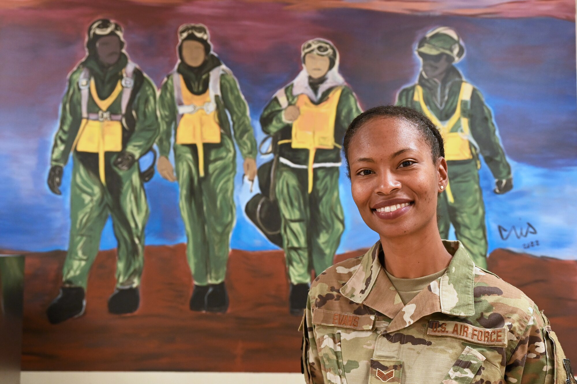 Slim, tall, with a contagious smile, Senior Airman Mia M. Evans, 332d Expeditionary Force Support Squadron services apprentice, incorporates art as a way to carry on the Red Tail legacy.