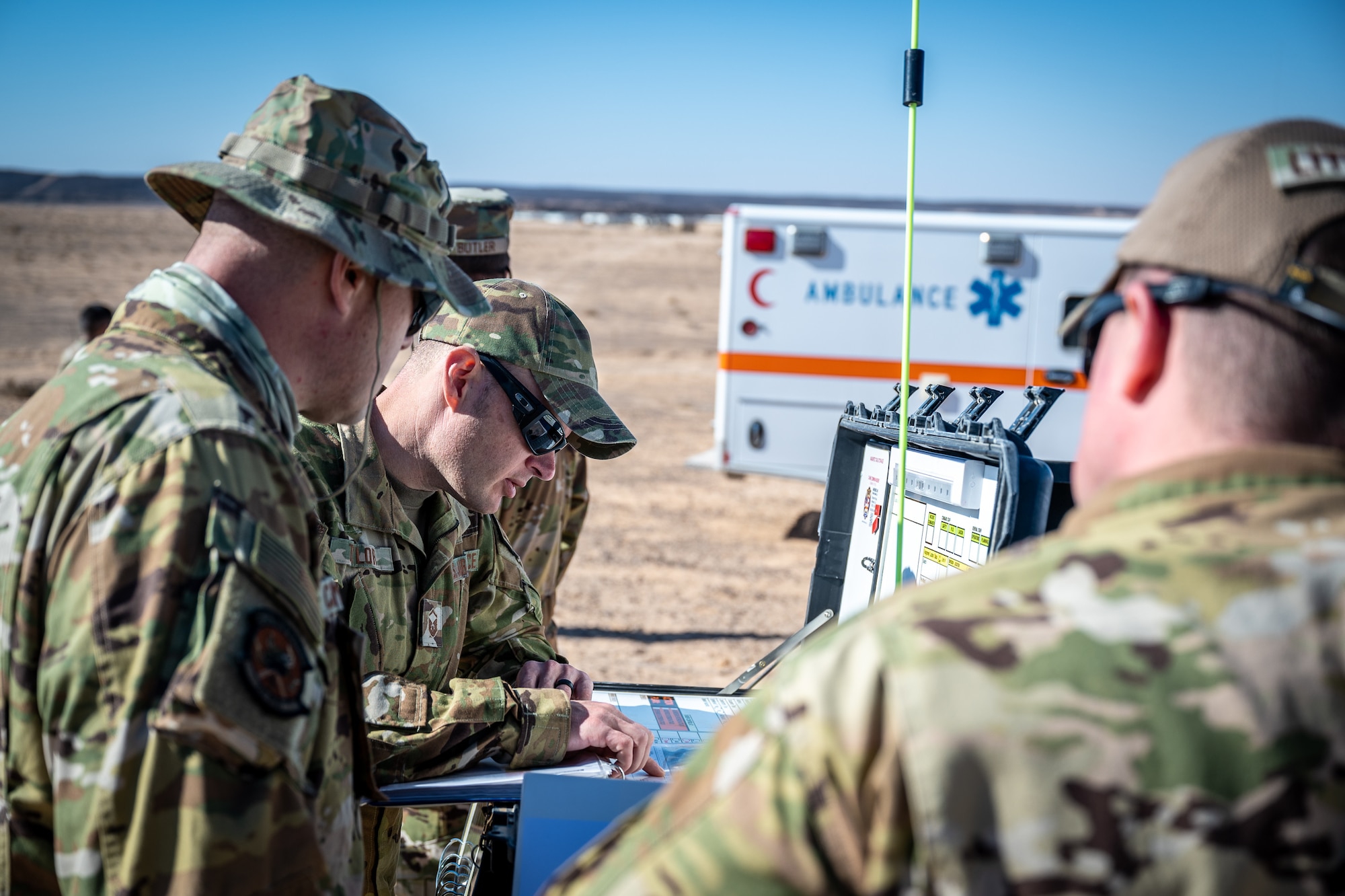 Members of the 332d Fire and Emergency Services establish an incident command center and begin coordination with security forces to cordon off the area and create a entrance control point during a counter small unmanned aircraft system training exercise in Southwest Asia Feb. 12, 2022. (U.S. Air Force photo by Master Sgt. Christopher Parr)