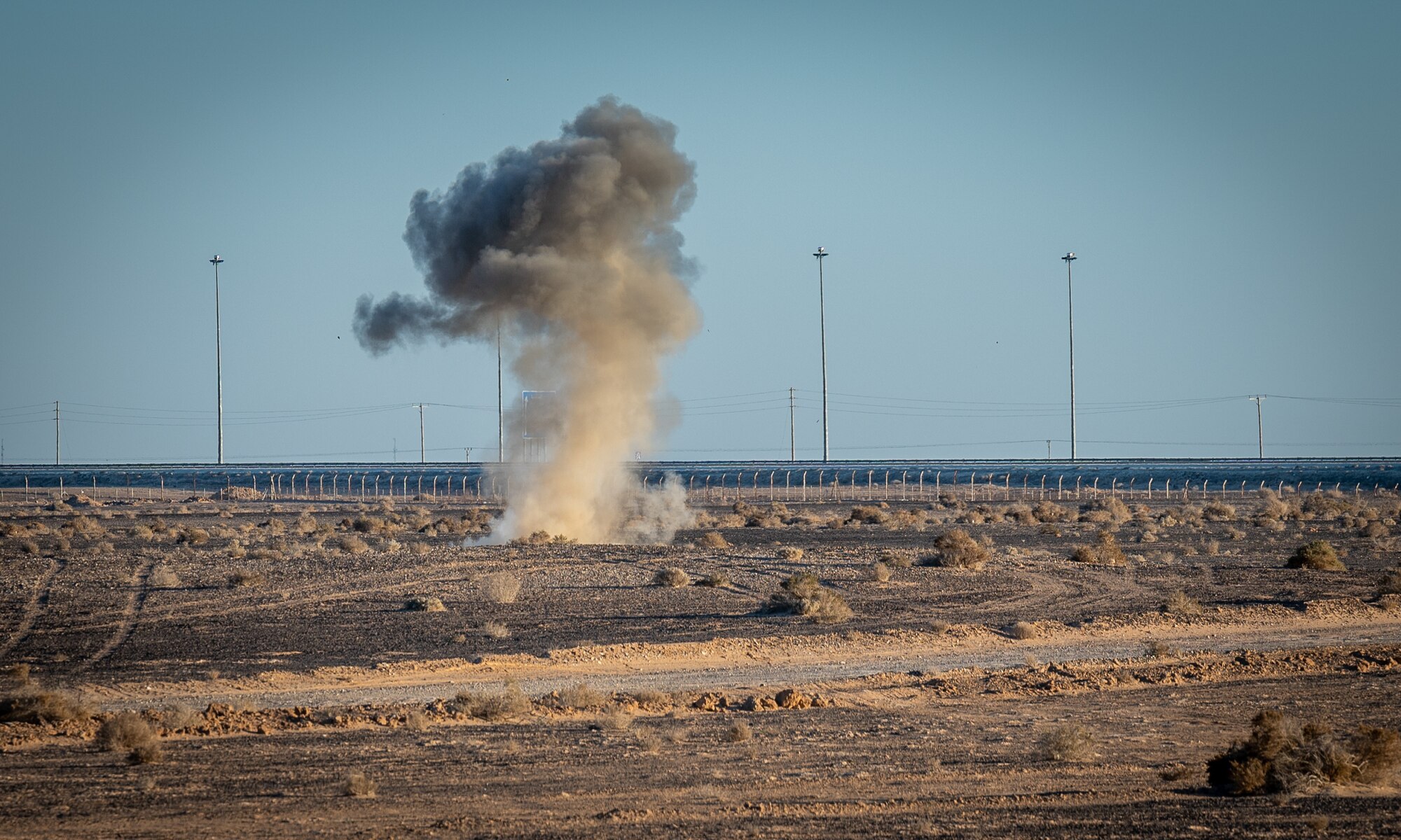 A plume of smoke rises up from a detonation of a small unmanned aircraft system by the 332d Expeditionary Explosive Ordnance Disposal unit during a counter SUAS training exercise in Southwest Asia Feb. 12, 2022. (U.S. Air Force photo by Master Sgt. Christopher Parr)