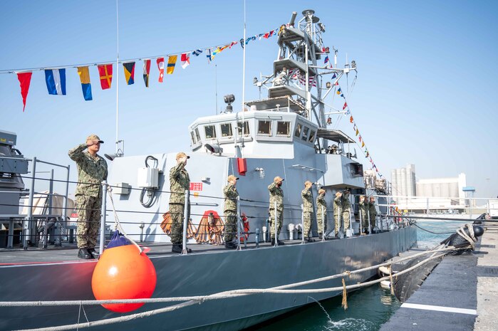 220223-N-OC333-1040 MANAMA, Bahrain (Feb. 23, 2022) Crewmembers assigned to patrol coastal ship USS Firebolt (PC 10) salute during the ship's decommissioning ceremony Feb. 23 at Naval Support Activity Bahrain. Firebolt commissioned in June 1995 and began conducting routine coastal patrol operations under U.S. 5th Fleet in 2003.