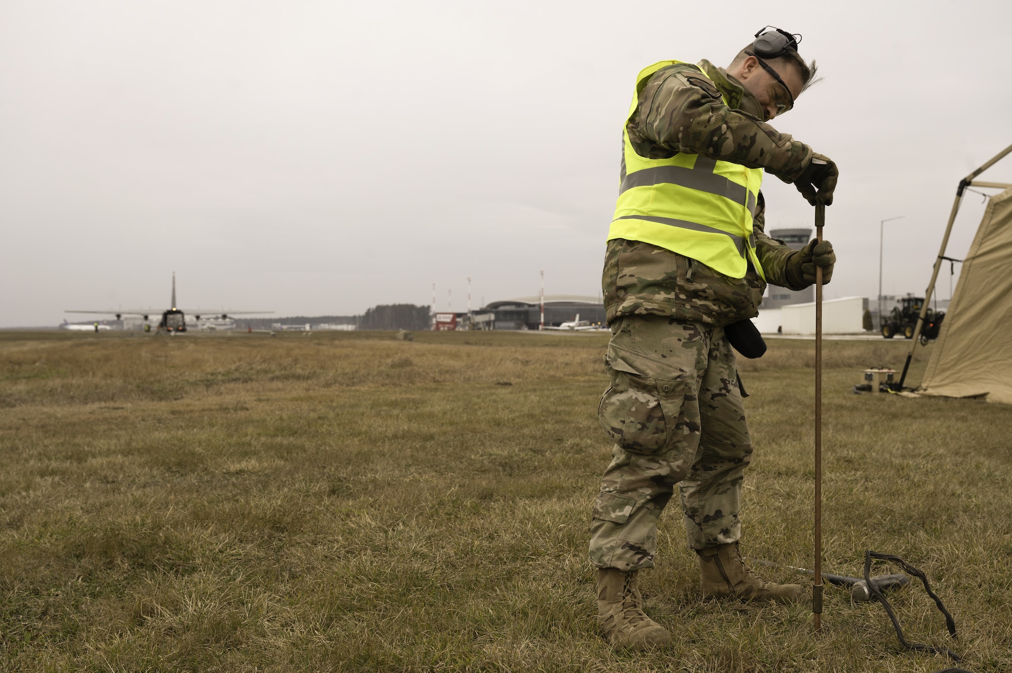 An Airman grounds a generator in Poland.
