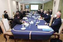 Capt. John Tully, director of Africa engagements, and members of the Royal Moroccan Navy Delegation, have a discussion at the 1st Navy Base Pier in Casablanca, Morocco, during a Morocco Staff Talks event Feb. 22, 2022.
