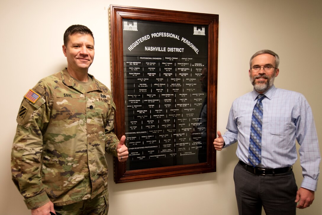 Lt. Col. Joseph Sahl, U.S. Army Corps of Engineers Nashville District commander, and Ben Rohrbach, Nashville District Engineering and Construction Division chief, recognize the newest licensed professionals affixed onto the “Registered Professional Personnel” board Feb. 23, 2022, at the district headquarters in Nashville, Tennessee. (USACE Photo by Lee Roberts)