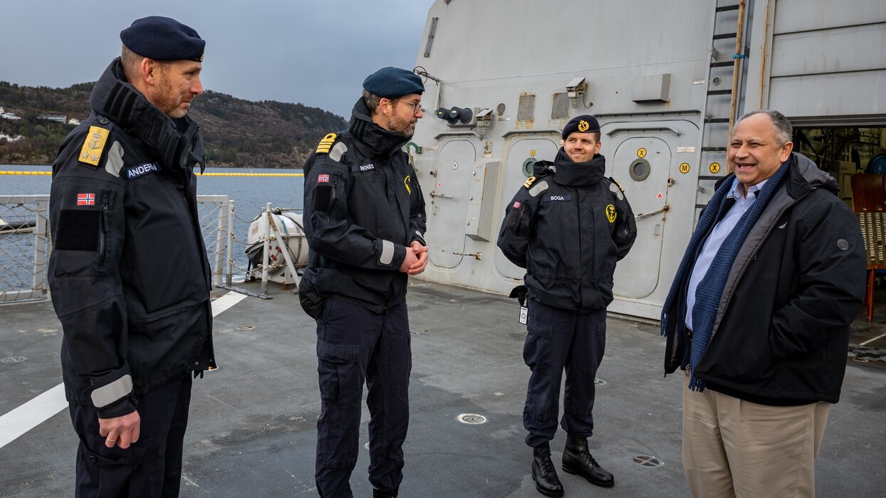 Secretary of the Navy Carlos Del Toro greets Norwegian Cmdr. Lars Ole Hoknes, commanding officer of HNoMS Thor Heyerdahl (F314), center, and Rear Adm. Rune Andersen, Chief of the Royal Norwegian Navy, left, in Bergen, Norway.