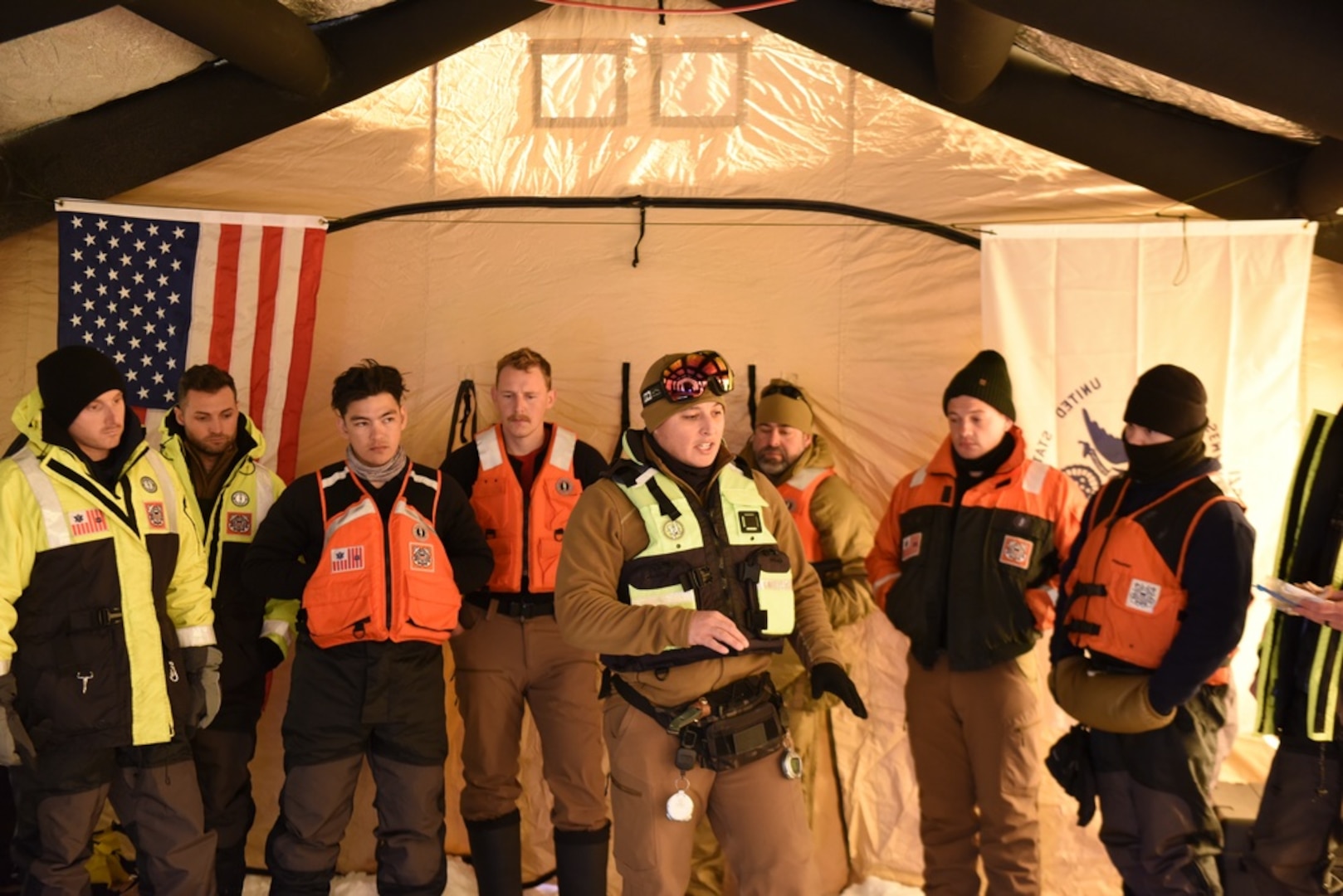U.S. Coast Guard Petty Officer 1st Class Joshua Bredesen, an instructor at the Cold Water Ice Diving course, explains the ice diving exercise to the dive students on Ferrel Lake at Camp Ripley, Minnesota, Feb. 3, 2022. The two week course is considered a special training for ice diving after attending Coast Guard Diver A-School. (U.S. Coast Guard photo by Petty Officer 3rd Class Omar Faba)