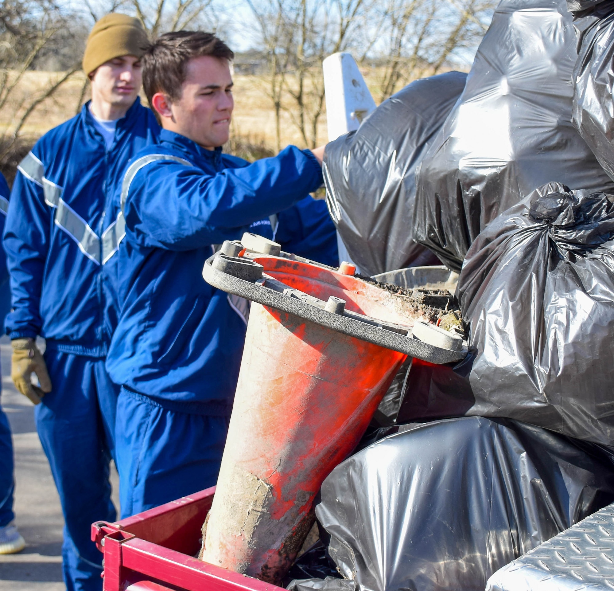 Airman 1st Class Karston Bright, 733rd Training Squadron student, loads trash bags onto an off-road golf cart at Stillman Park, Joint Base San Antonio-Lackland, Texas, Feb. 18, 2022. Four students in the 733rd TRS volunteered in a joint cleanup event coordinated by the 502nd Installation Support Group to remove garbage and debris from on-base parks and waterways. (U.S. Air Force photo by Airman Mark Colmenares)