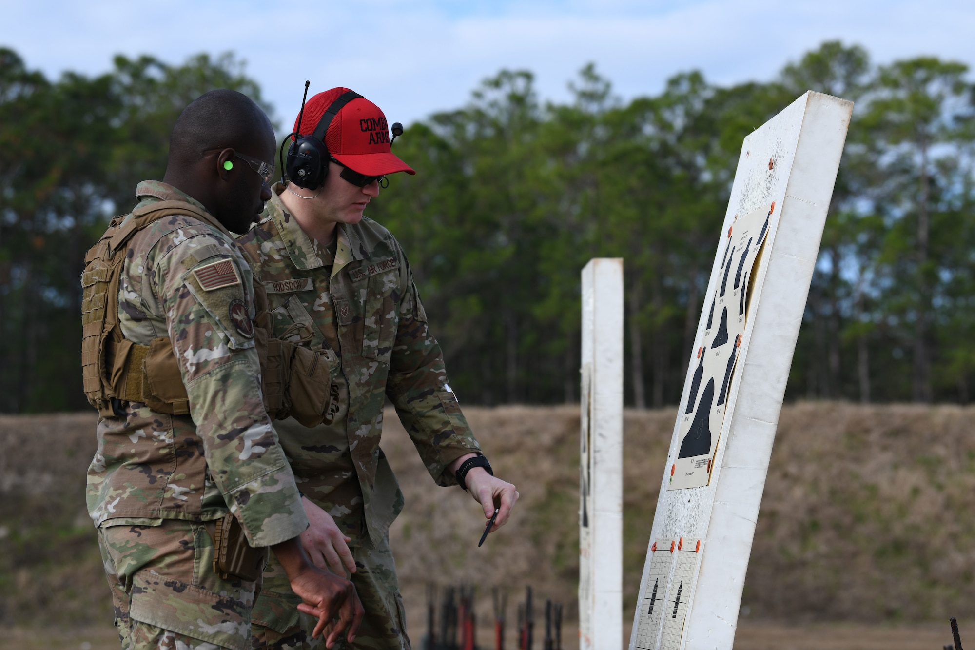 Airmen examine a target during a qualification course at Hurlburt Field, Florida, Feb. 16, 2022