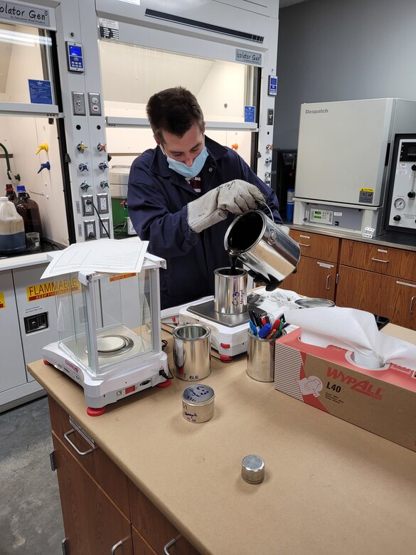 U.S. Army Engineer Research and Development Center (ERDC) technician, Joey Bonelli, subsamples a graphene-enhanced asphalt binder. This binder has the potential to increase asphalt strength and longevity. (U.S. Army Corps of Engineers photo)