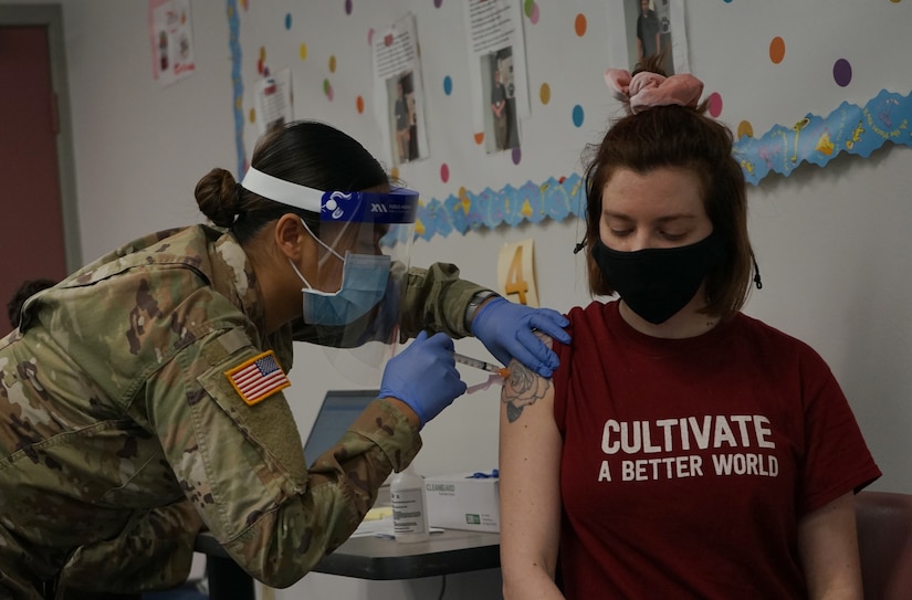 Spc. Han Thach, left, a combat medic with the Pennsylvania National Guard, administers the COVID-19 vaccine to a patient at Capital Area Intermediate Unit in Enola, Pa., on March 26, 2021. Thach was part of the Pa. National Guard mission to vaccinate Pennsylvania teachers, child-care workers and other staff. (U.S. Army photo by Sgt. 1st Class Matthew Keeler)