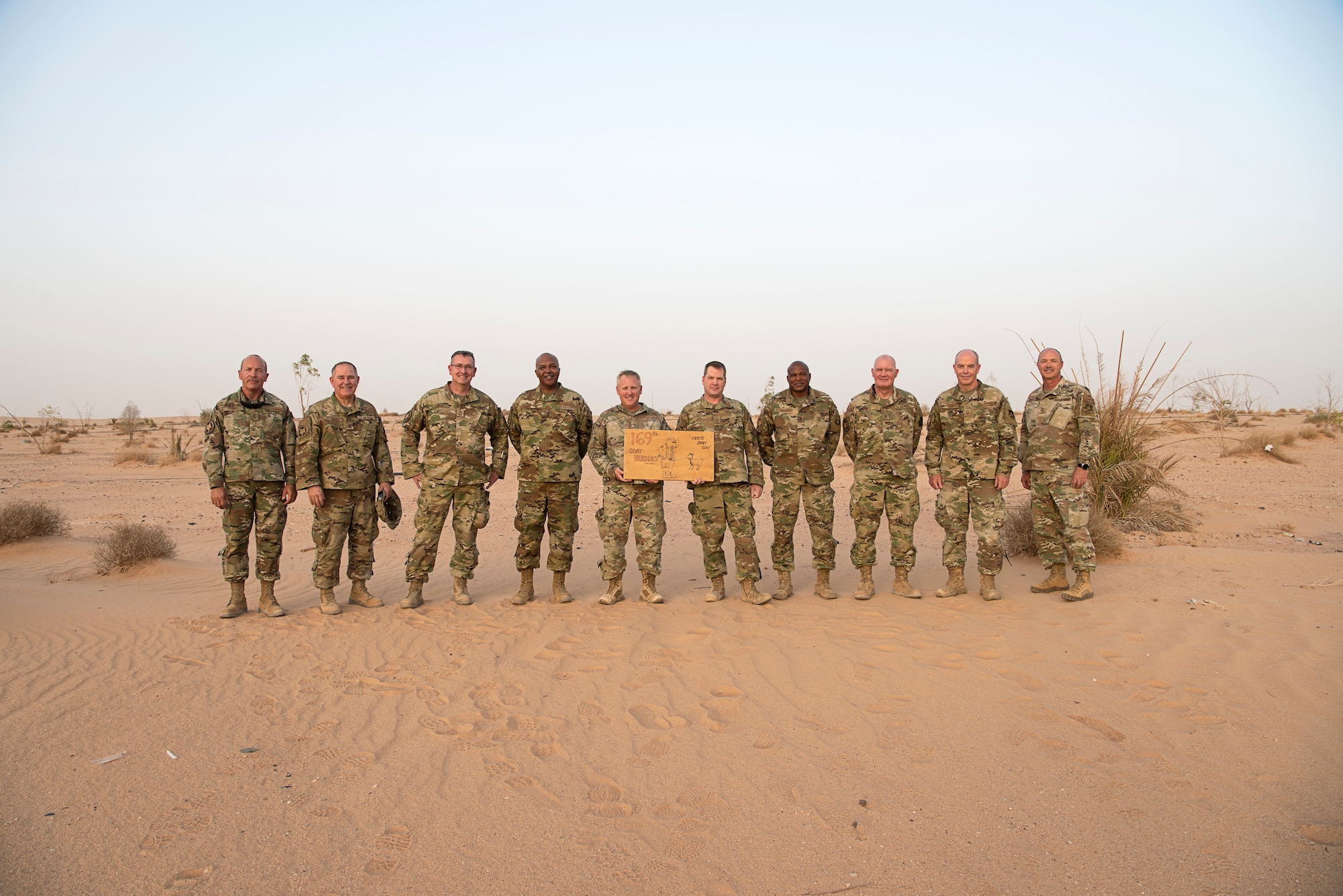 U.S. Air Force Airmen from the 157th Expeditionary Fighter Generation Squadron pose for a picture at the site of the life support area used by coalition forces during Operation DESERT STORM in 1991 at Prince Sultan Air Base, Kingdom of Saudi Arabia, June 16, 2021. From left: Chief Master Sgt. Anthony Terry, Senior Master Sgt. Mark Tanner, Chief Master Sgt. Charles Bowen, Master Sgt. Charles Randle, Senior Master Sgt. Charles Talbert, Senior Master Sgt. Martin Gladden, Master Sgt. Robert Woodard, Senior Master Sgt. Burman Jones, Senior Master Sgt. Jeffrey Orr, Senior Master Sgt. Michael Puck.  The "Swamp Fox" Airmen from the South Carolina Air National Guard are deployed to PSAB to project combat power and help bolster defensive capabilities against potential threats in the region. (U.S. Air National Guard photo by Senior Master Sgt. Carl Clegg)