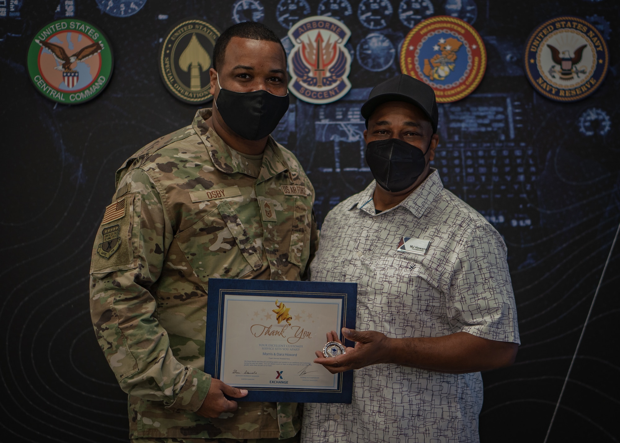 U.S. Air Force Chief Master Sgt. Kevin Osby, Army and Air Force Exchange Service’s senior enlisted advisor, awards Morris Howard for his excellence in customer service at the Exchange at MacDill Air Force Base, Florida, Feb. 22, 2022.