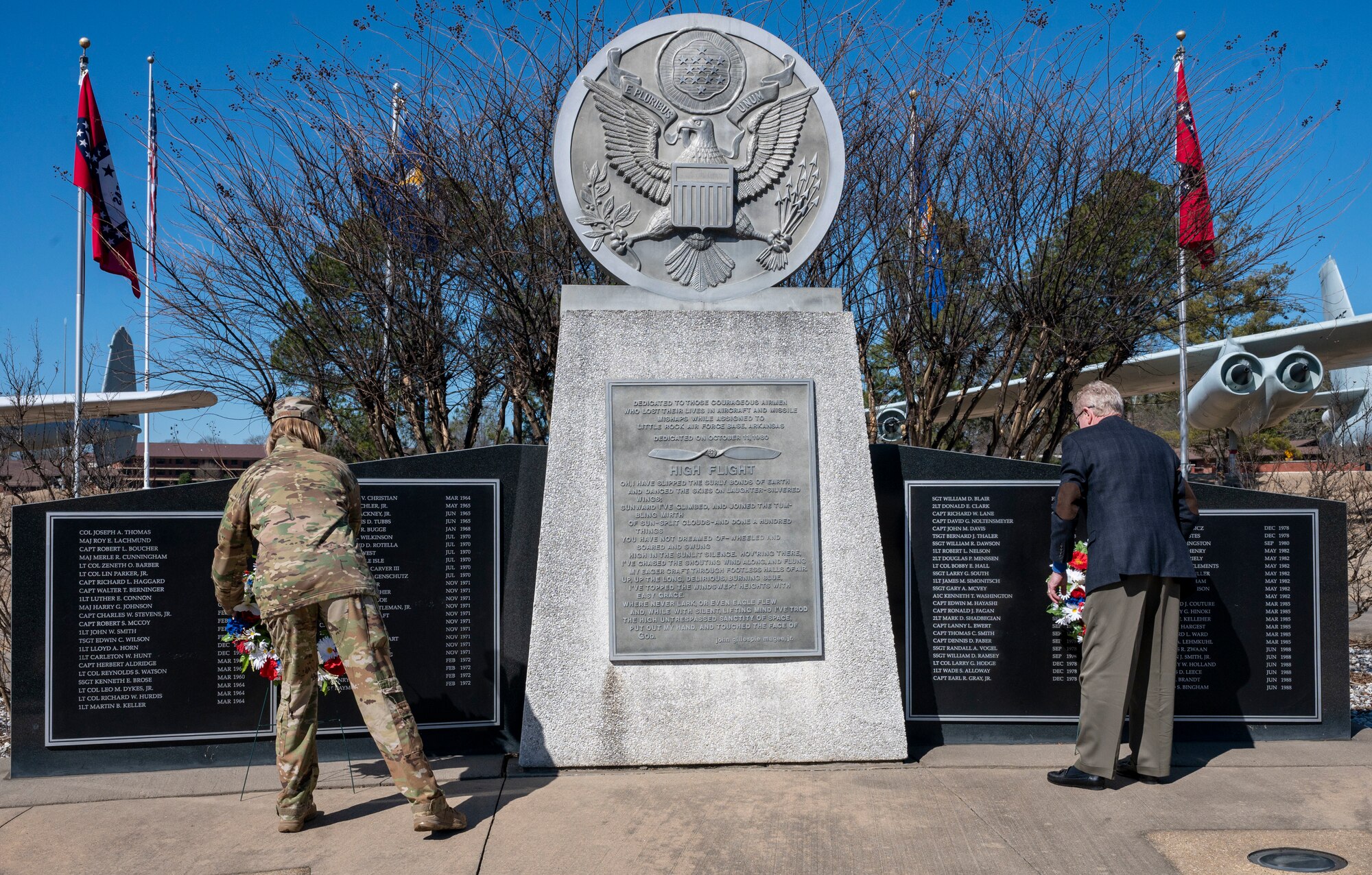 Col. Angela Ochoa, 19th Airlift Wing commander, and Jim Breen, brother of Capt. Edward Breen, lay wreaths