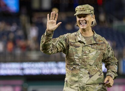 Air Force Maj. Gen. Sherrie McCandless, commanding general of the District of Columbia National Guard, waves to the crowd after throwing the ceremonial first pitch during National Guard Day at Nationals Park in Washington, Aug. 13, 2021.