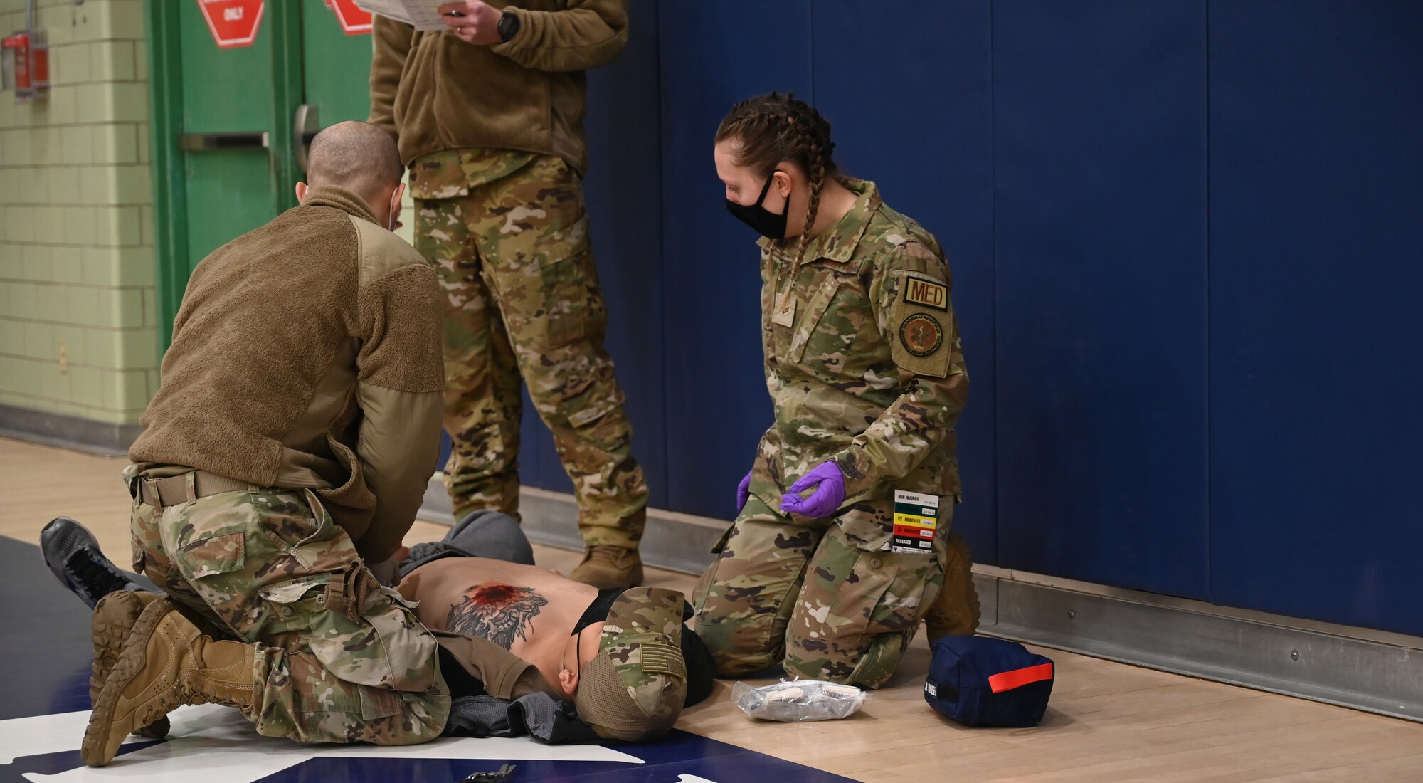 Medics performs triage to role player casualty