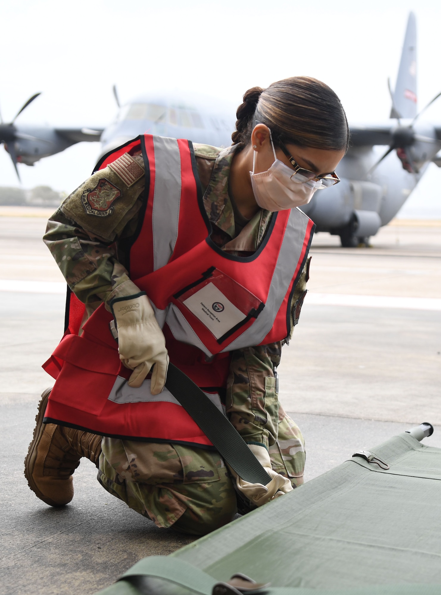 U.S Air Force Airman 1st Class Elizabeth Contreras, 81st Healthcare Operations Squadron medical technician, prepares a stretcher for patients during the National Disaster Medical System Exercise outside the 41st Aerial Port Squadron building at Keesler Air Force Base, Mississippi, Feb. 17, 2022. Keesler's Federal Coordination Center was activated and received more than 20 patients during the exercise scenario, which included the New Madrid Fault erupting, sparking an earthquake to occur in Tennessee causing extensive damage and injuring many people. Members of the 81st Medical Group participated in the event in order to better prepare themselves for real-world situations. (U.S. Air Force photo by Kemberly Groue)