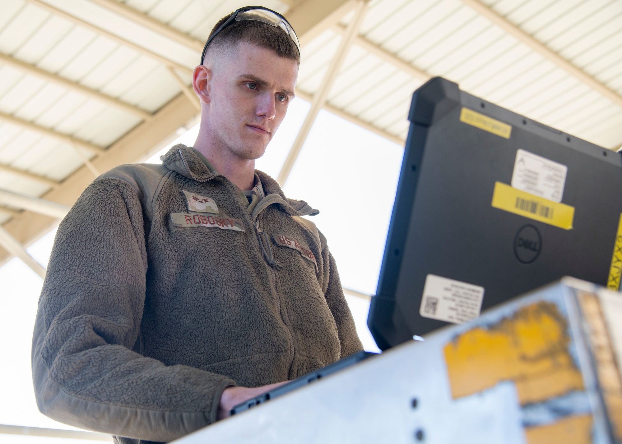 U.S. Air Force Senior Airman Aaron Robosky, 61st Aircraft Maintenance Unit F-35A Lightning II assistant dedicated crew chief, uses a wireless capable ruggedized laptop during an F-35 inspection Feb. 3, 2022, at Luke Air Force Base, Arizona. The 56th Fighter Wing Program Integration Office purchased 400 Rugged Extreme Business laptops with wireless capabilities for various squadrons around base to increase Airmen’s ability to update maintenance systems in real time. (U.S. Air Force photo by Staff Sgt. Collette Brooks)