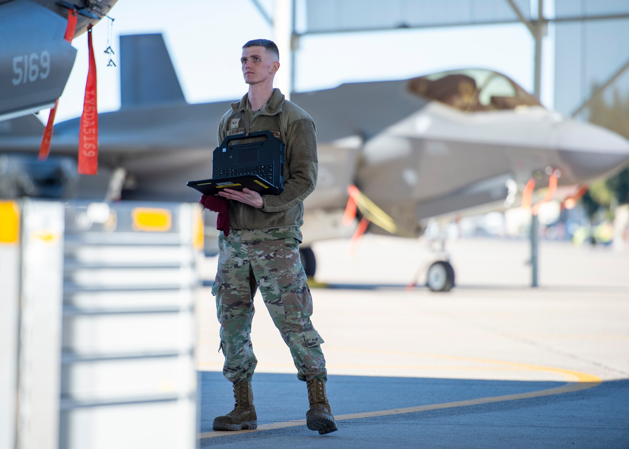 U.S. Air Force Senior Airman Aaron Robosky, 61st Aircraft Maintenance Unit F-35A Lightning II assistant dedicated crew chief, uses a wireless capable ruggedized laptop during an F-35 inspection Feb. 3, 2022, at Luke Air Force Base, Arizona. The laptops are used daily to check servicing levels, accomplish aircraft inspections and sign off on forms, which increases maintainers’ ability to support the world's greatest fighter pilots and combat-ready Airmen. (U.S. Air Force photo by Staff Sgt. Collette Brooks)