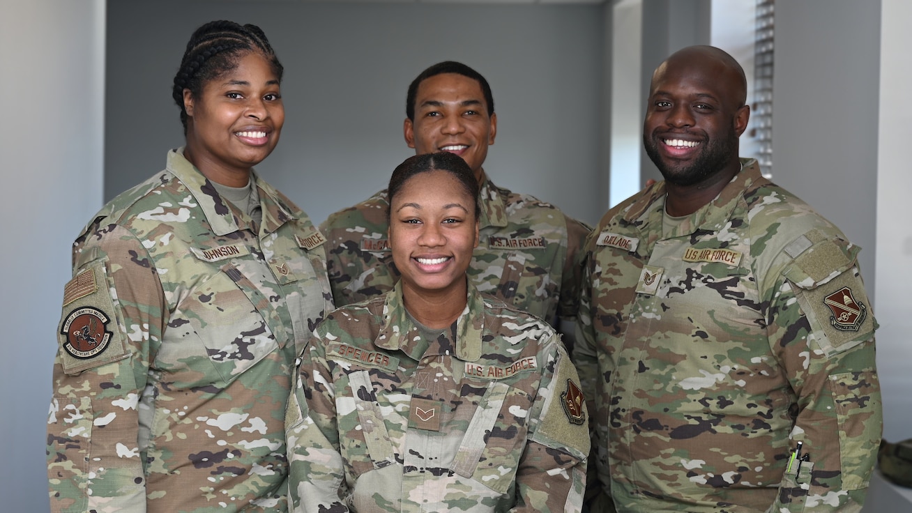 Members of the Joint Base Andrews and Joint Base Anacostia-Bolling African American Heritage Committee stand for a group photo on JBAB, Washington, D.C., Jan. 27, 2022. From the left, U.S. Air Force Staff Sgt. Talia Johnson, NCO in charge of the surgical intensive care unit at Walter Reed Medical Facility; Senior Airman Kortnee Spencer, 316th Force Support Squadron personnelist; Tech. Sgt. Roy McCalister III, NCOIC of unaccompanied housing in the 11th Civil Engineer Squadron on JBAB; and Tech. Sgt. Kayode Ojelade, NCOIC of Individual Ready Reserve in the 316th Force Support Squadron on JBA. The mission of the AAHC is to educate Airmen on Black history and bring the community together to celebrate the culture. The committee coordinated events for people living and working on JBAB and JBA during the month of February in observance of Black History Month. (U.S. Air Force photo by Airman 1st Class Anna Smith)