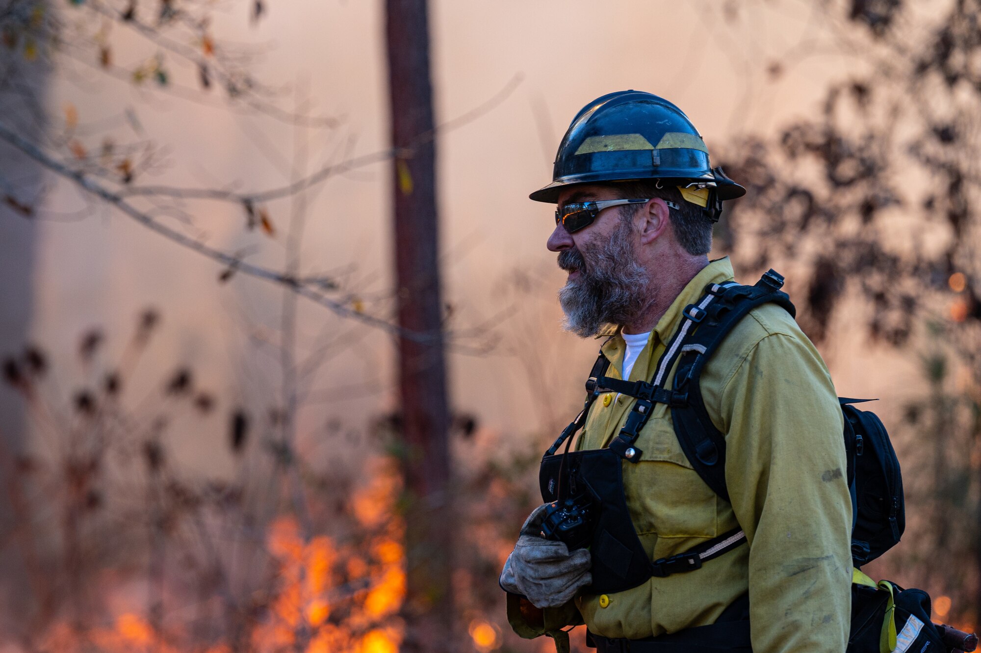 Matt Johnson, U.S. Fish and Wildlife fire management specialist, completes a perimeter check during a controlled burn at Barksdale Air Force Base, Louisiana, Jan. 28, 2022.