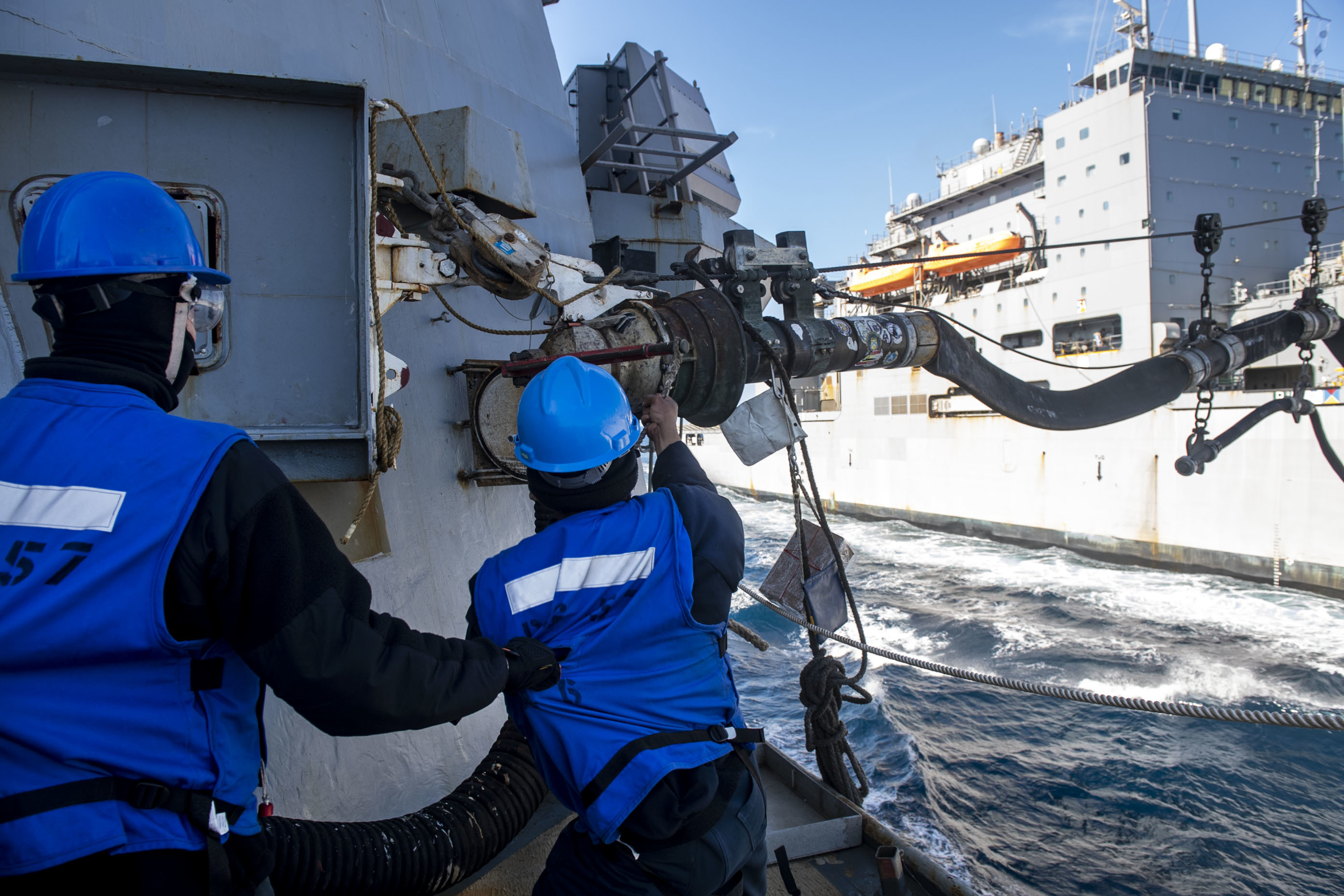 Sailors detach a fuel probe during a replenishment-at-sea with Dry Cargo and Ammunition ship USNS Robert E. Perry (T-AKE-5) aboard the Arleigh Burke-class guided-missile destroyer USS Mitscher (DDG 57).