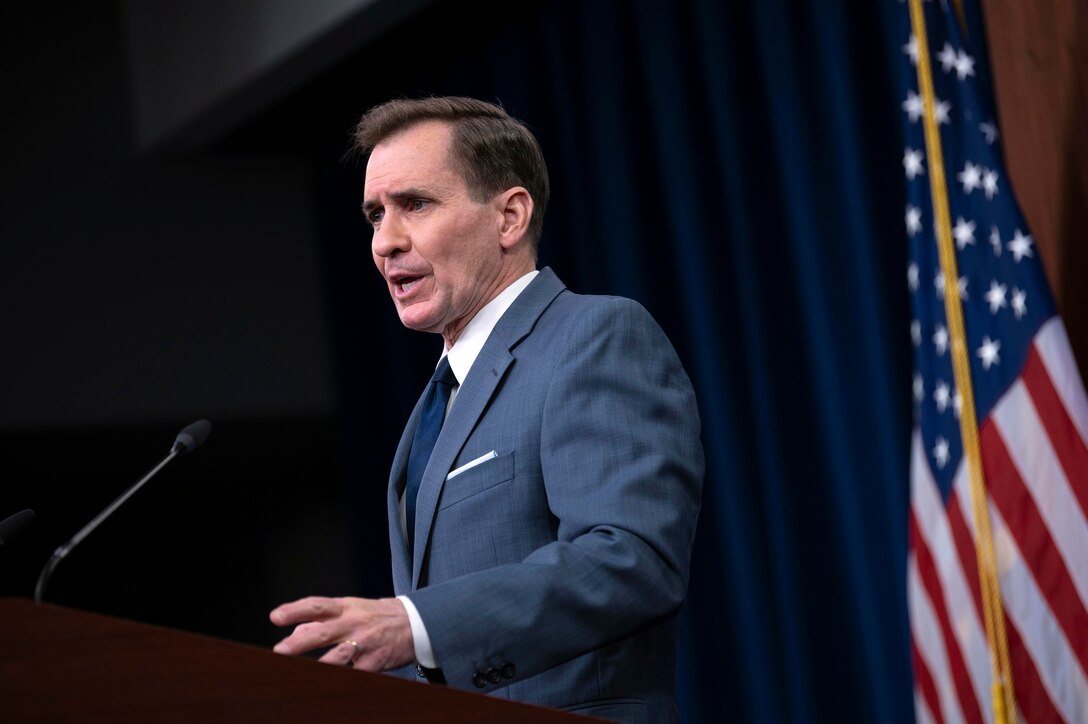 A civilian speaks at a lectern.