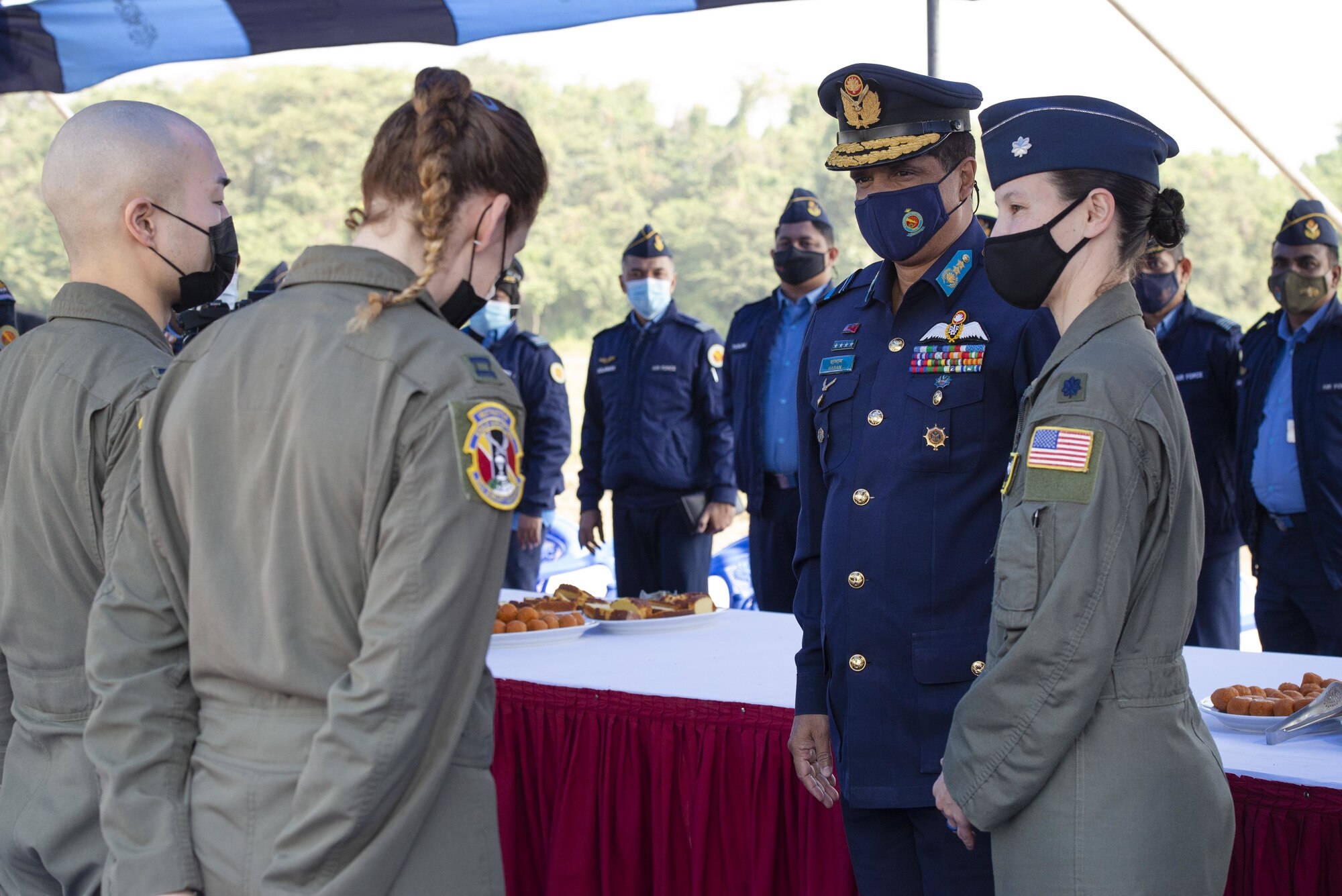 U.S. Air Force Lt. Col. Kira Coffey, right, 36th Expeditionary Airlift Squadron Commander, introduces Bangladesh Air Force Air Vice Marshal Hasan Mahmood Khan, to 36th EAS aircrew during the Exercise Cope South 2022 opening ceremony Feb. 19, 2022, at the BAF Base Bangabandhu, Bangladesh.
