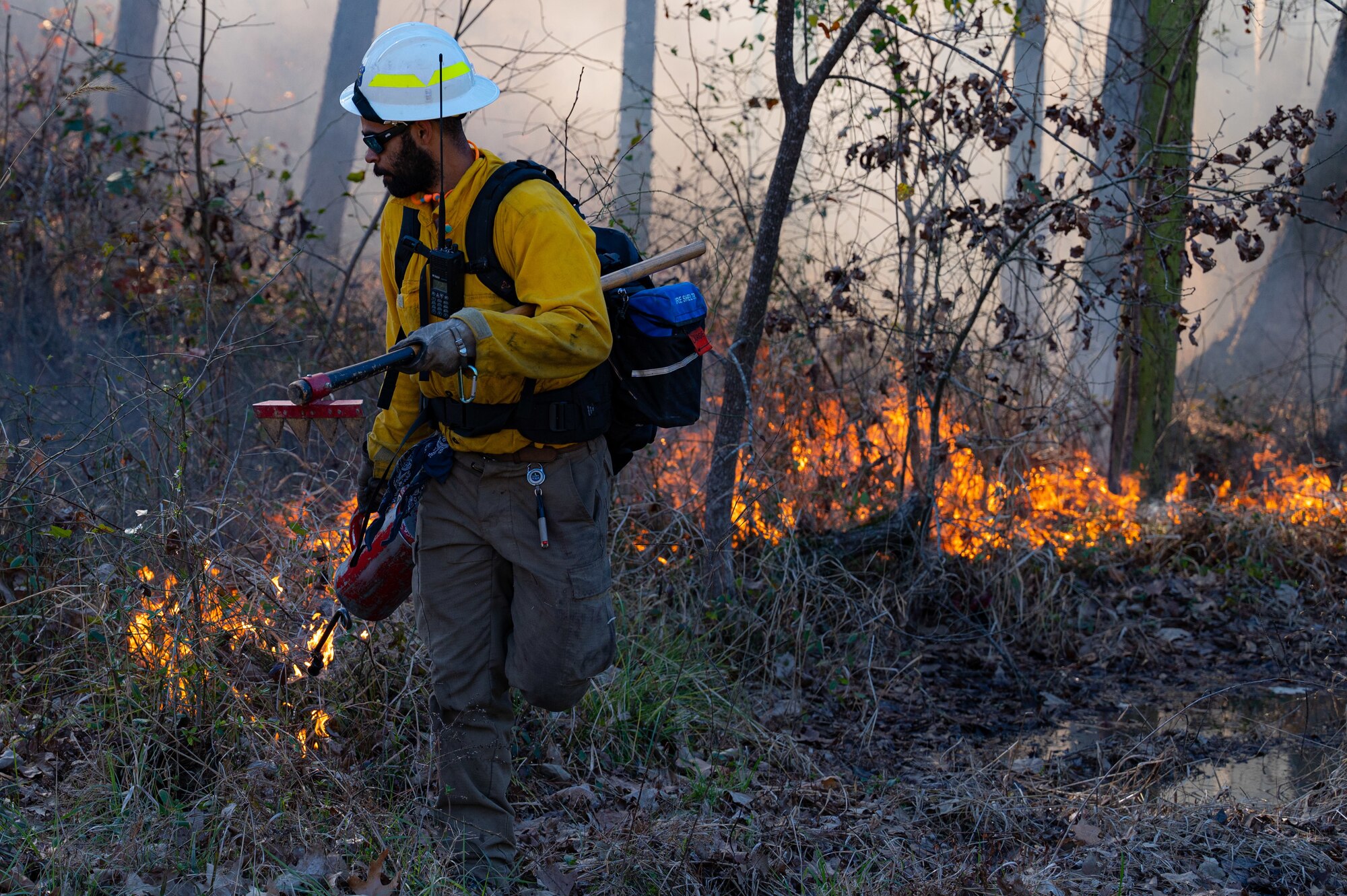 Melcolm Crutchfield, U.S. Fish and Wildlife seasonal firefighter, begins a controlled burn on Barksdale East Reservation, Jan. 28, 2022.