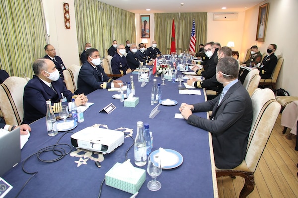 Capt. John Tully, director of Africa engagements, and members of the Royal Moroccan Navy Delegation, have a discussion at the 1st Navy Base Pier in Casablanca, Morocco, during a Morocco Staff Talks event Feb. 22, 2022.