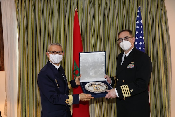 Capt. John Tully, director of Africa engagements, right, and Head of Delegation, Royal Moroccan Navy, left, pose for a photo on the 1st Navy Base Pier in Casablanca, Morocco, after a Morocco Staff Talks event Feb. 22, 2022.