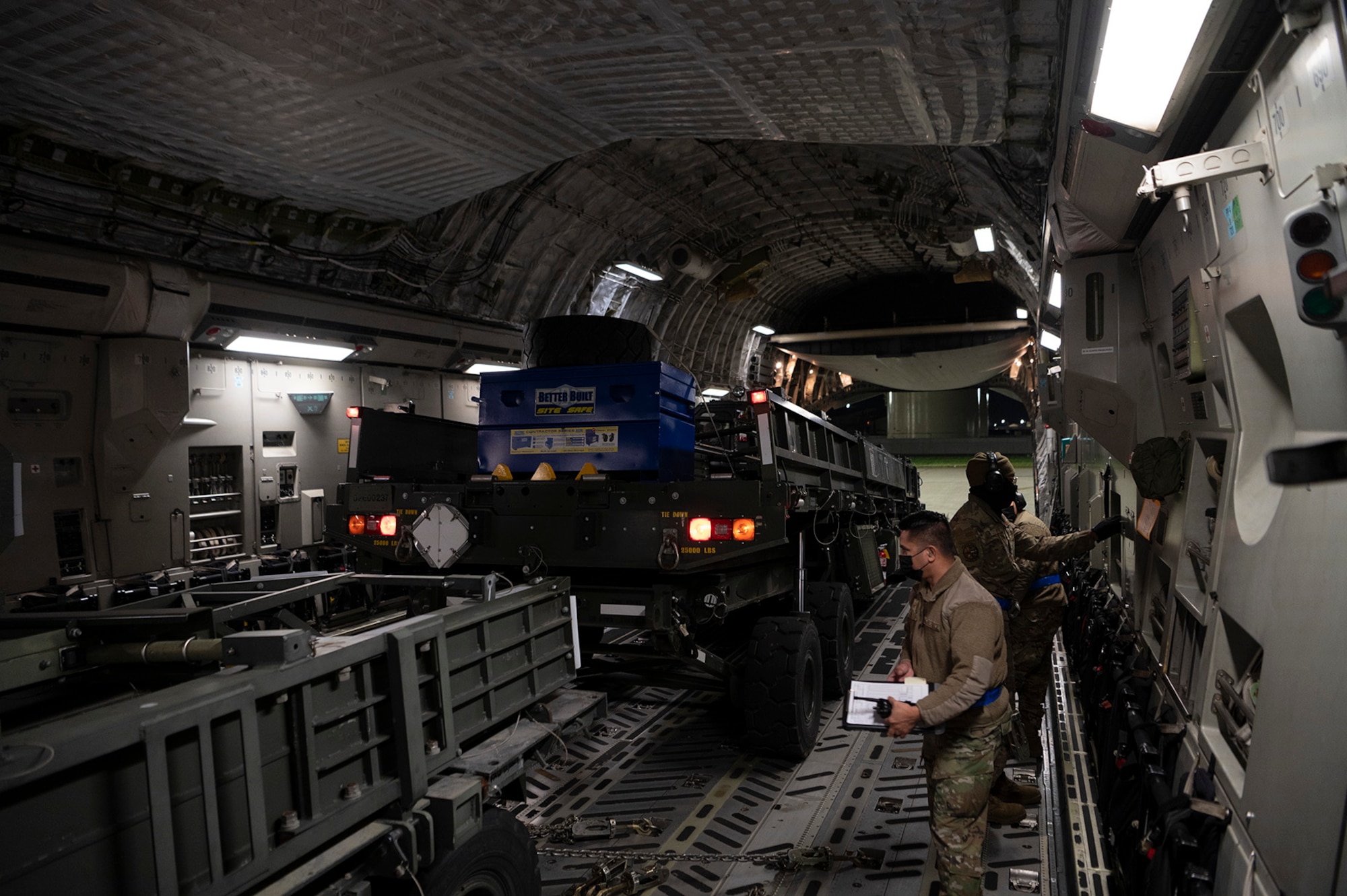 Airmen load cargo onto a plane