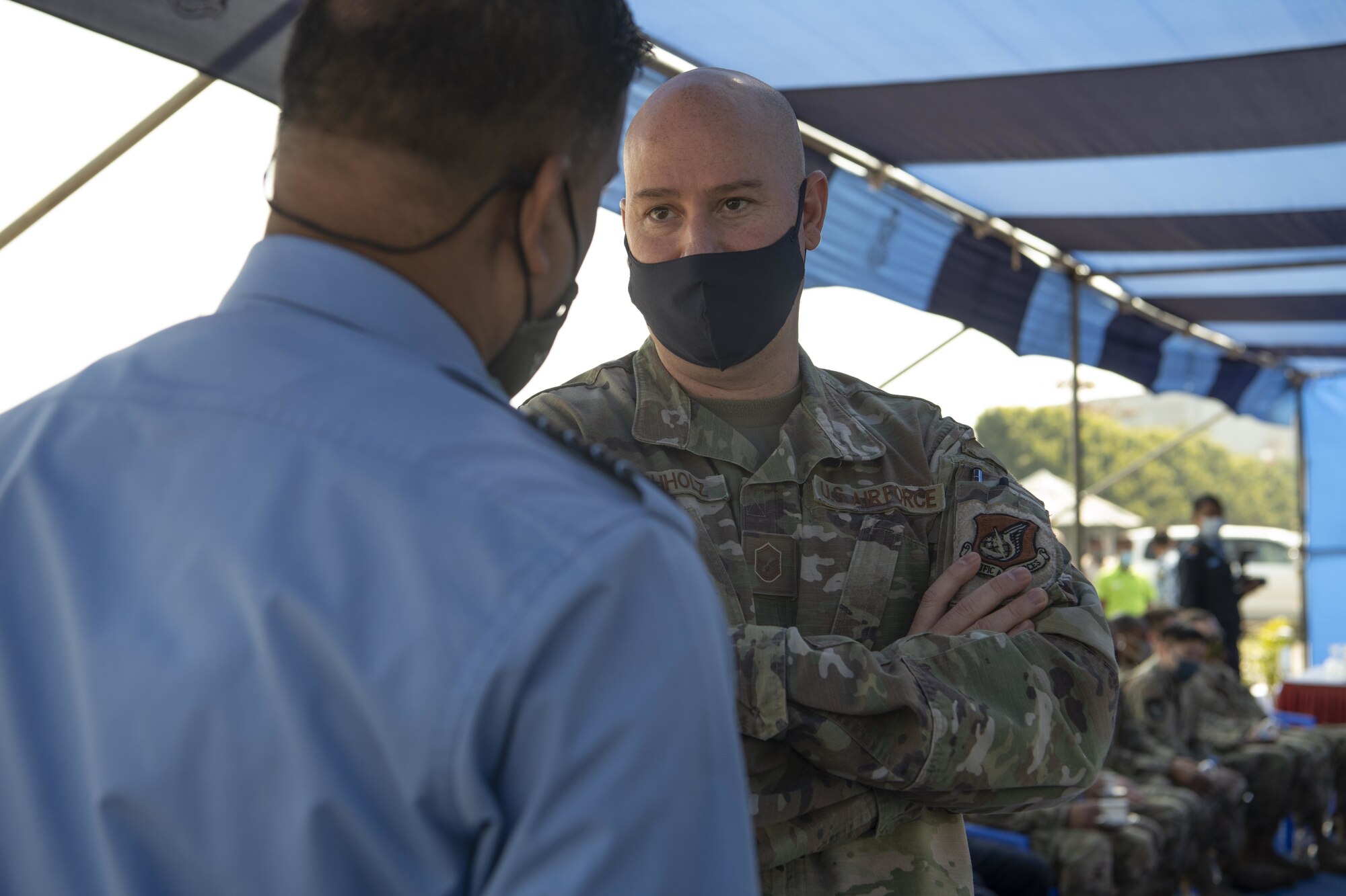 Master Sgt. Justin Buchholz, 36th Expeditionary Airlift Squadron maintenance superintendent, talks with a Bangladesh Air Force (BAF) member during Exercise Cope South 2022’s opening ceremony Feb. 19, 2022, at BAF Base Bangabandhu, Bangladesh.