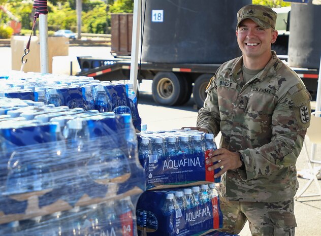 U.S. Army Sgt. Owen Bailey, assigned to the 95th Engineer Company, 84th Engineer Battalion, 130th Engineer Brigade, prepares to hand out water at the Navy Exchange Moanalua Terrace water distribution station.