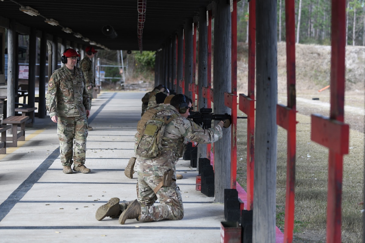 Airmen fire weapons during a qualification course at Hurlburt Field, Florida, Feb. 16, 2022