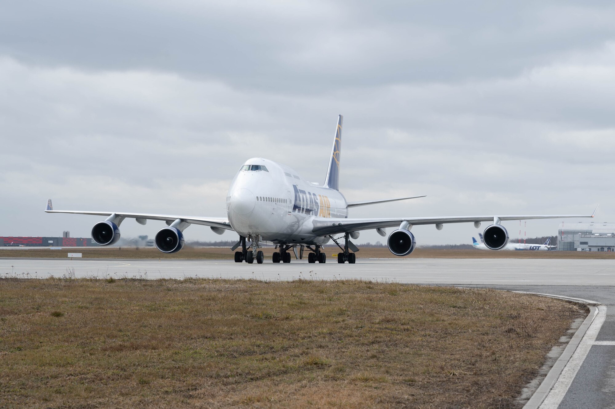 A Boeing 747 aircraft is marshaled into its spot.
