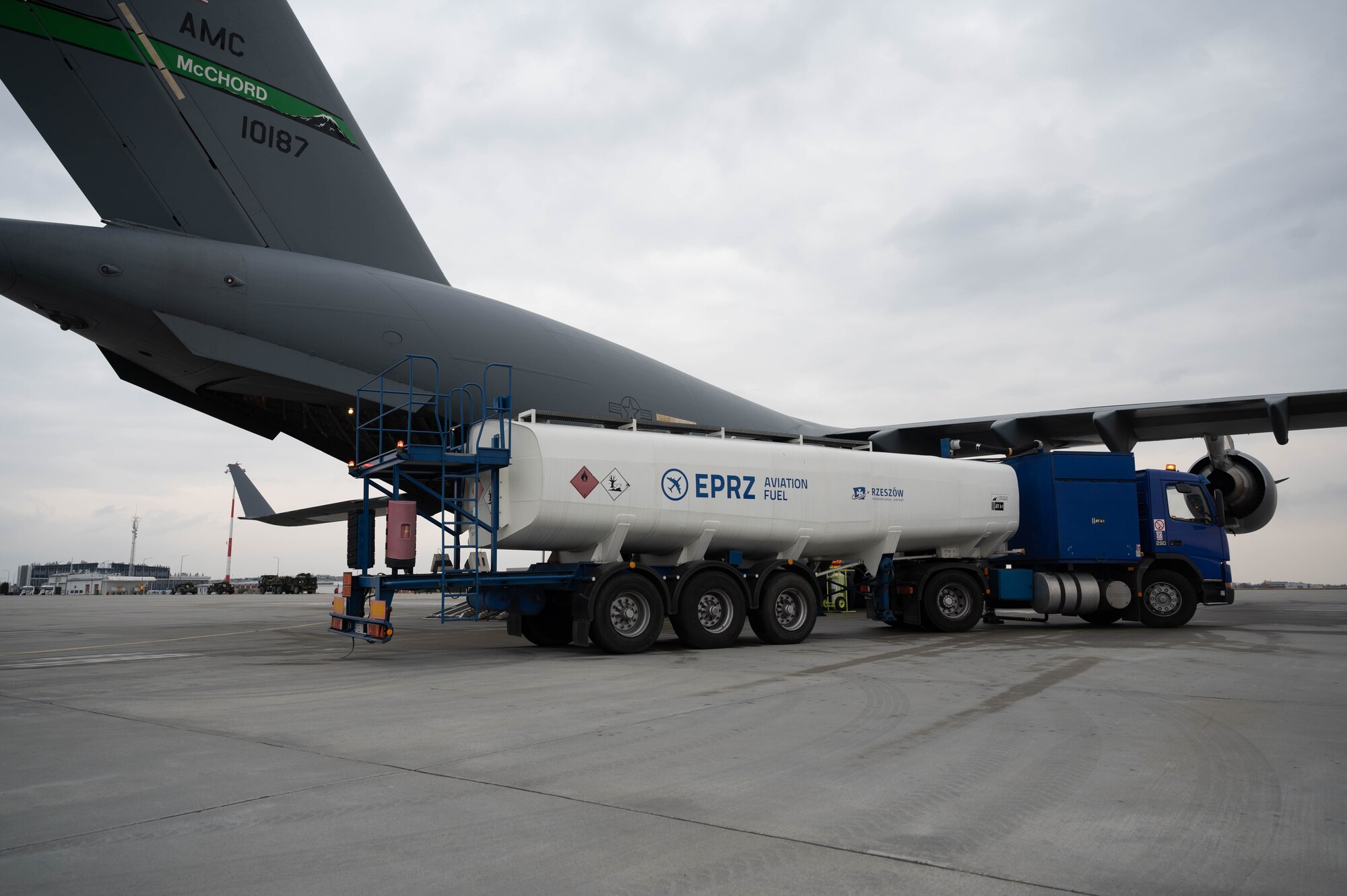 A fuel truck rests next to a C-17 Globemaster III.