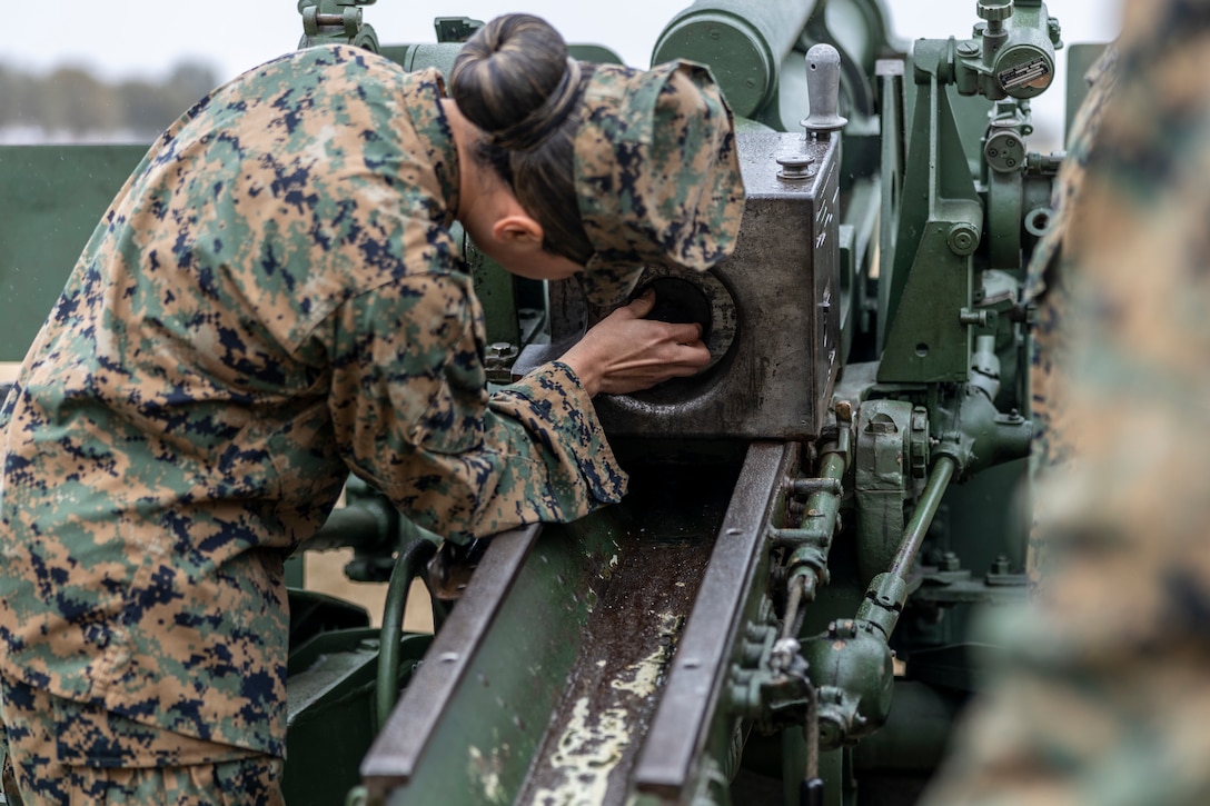 U.S. Marine Corps Cpl. Teresa Amaya, a cannon loader with Kilo Battery, 2d Battalion, 10th Marines, loads a 105mm cannon during the President’s Day 21-gun salute at W.P.T. Hill Field on Marine Corps Base Camp Lejeune, North Carolina, Feb. 21, 2022.