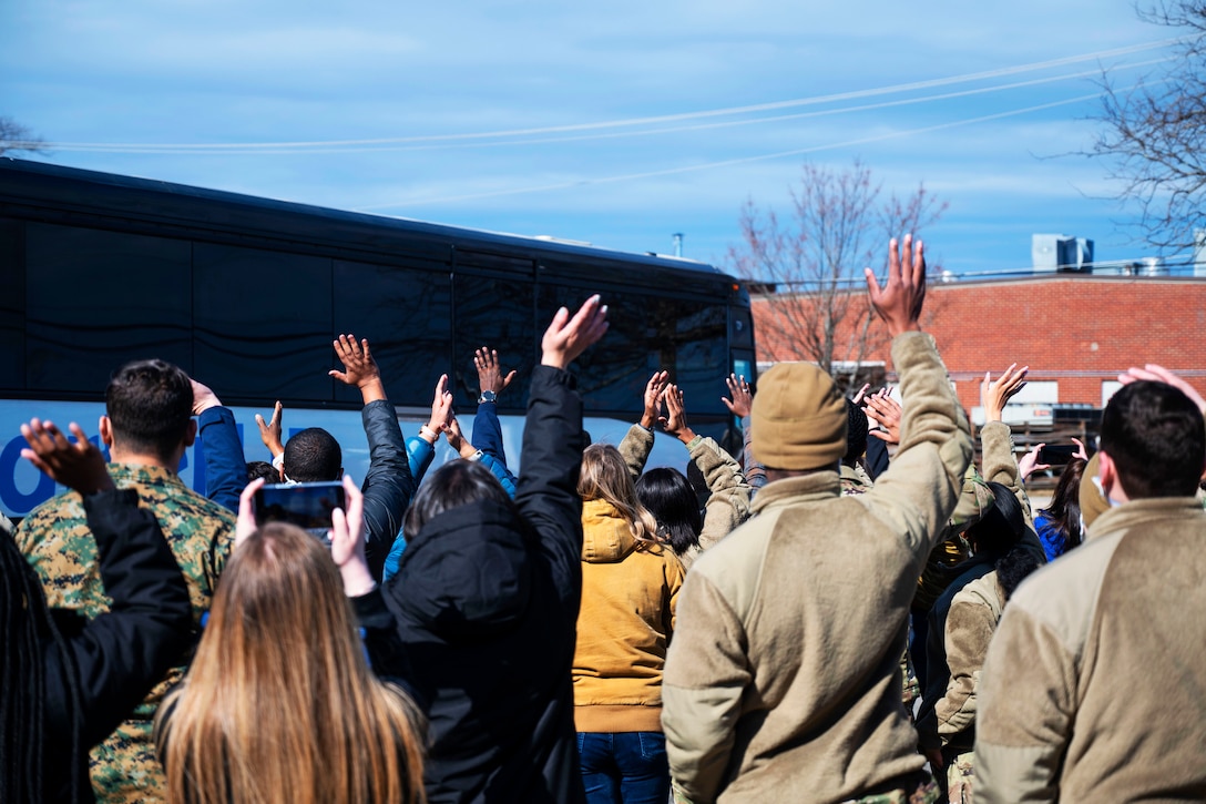 Soldiers assigned to Task Force Liberty wave goodbye to Afghan guests.