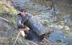 Man picks barrel out of water