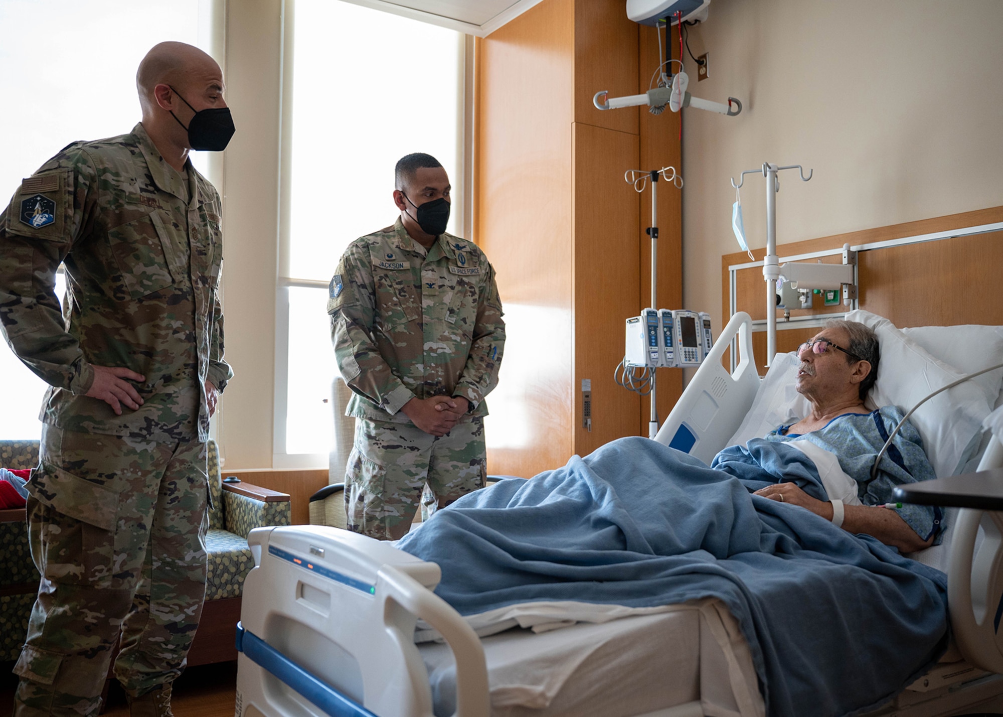 U.S. Space Force Col. Marcus Jackson, Buckley Garrison commander, and U.S. Air Force Chief Master Sgt. Robert Devall, Buckley Garrison command chief, visit a veteran at the Rocky Mountain Regional VA Medical Center in Aurora, Colo., Feb. 15, 2022. The National Salute to Veteran Patients occurs the week of Feb. 14 and pays tribute to just under 100,000 patients a day that receive medical treatment in VA medical facilities. (U.S. Space Force photo by Senior Airman Haley N. Blevins)