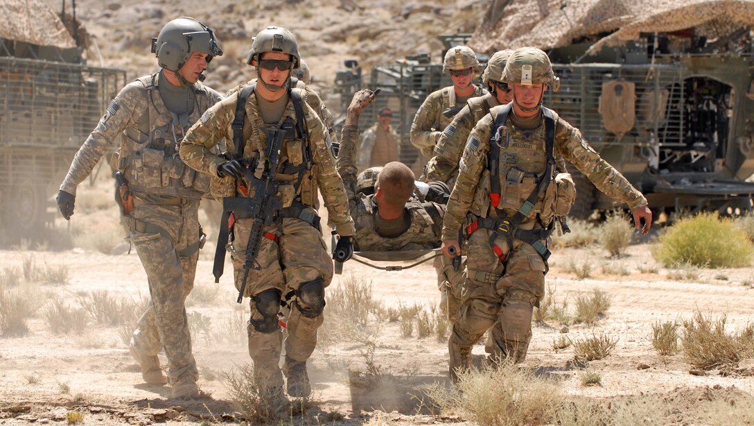 U.S. Army Pfc. Shawn Williams of the 1st Stryker Brigade Combat Team, 25th Infantry Division, based in Fort Wainwright, Alaska, gives the thumbs-up to members of his unit as he is evacuated after being injured by a roadside bomb, Friday, June 17, 2011, in the Kandahar province of Afghanistan