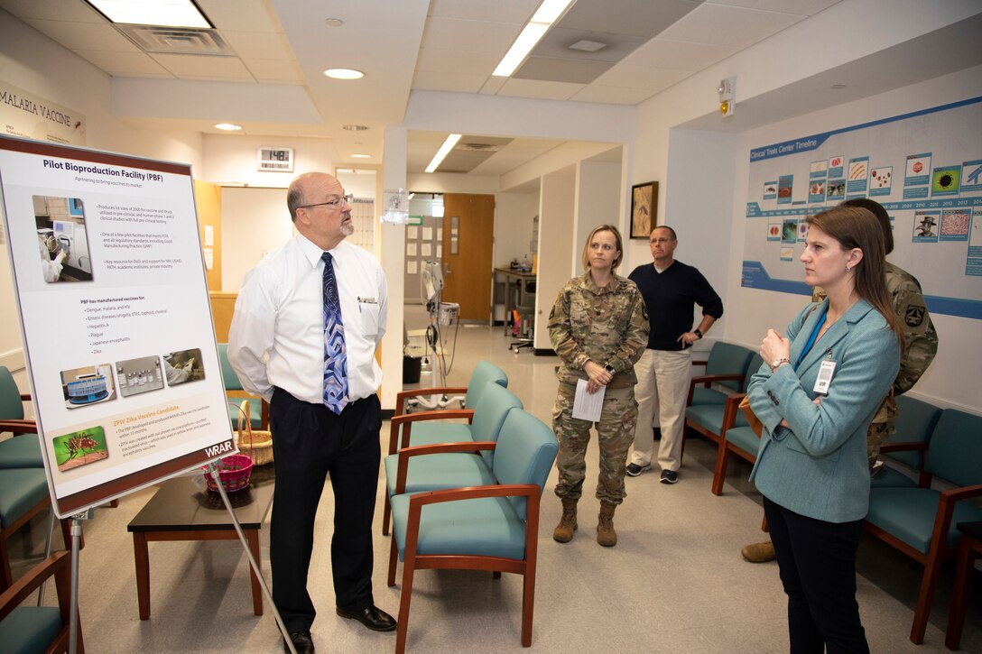 Richard Millward (left) Deputy Chief of the Pilot Bioproduction Facility (PBF) at the Walter Reed Army Institute of Research (WRAIR), explains the capabilities of the PBF  to congressional staffer Jacqueline Ripke (right) during a tour, February 18, 2020