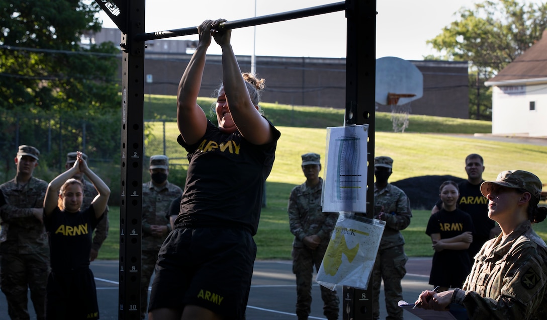 Sgt. Trista Geiszler participates in the leg tuck event, as part of the inaugural Headquarters and Headquarters Company Commanders Cup, June 30, 2021