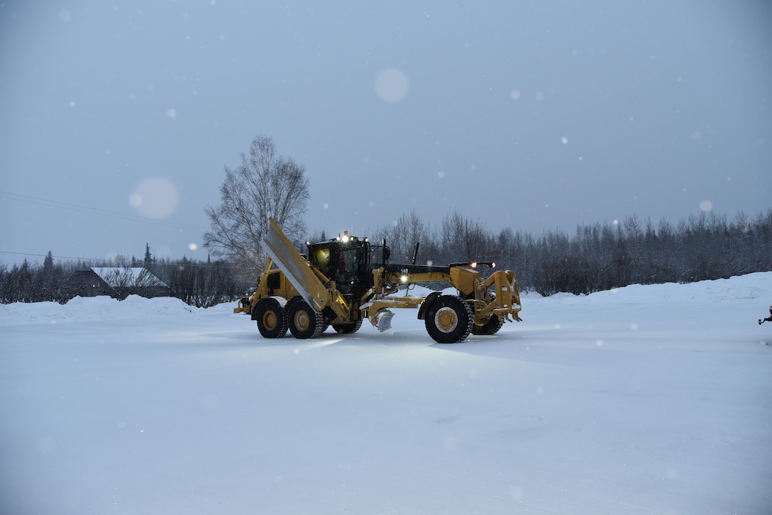 Ryan Lucke, engineering equipment operator for the U.S. Army Corps of Engineers – Alaska District, drives a grader vehicle on Dec. 7 at the Chena River Lakes Flood Control Project in North Pole, Alaska.