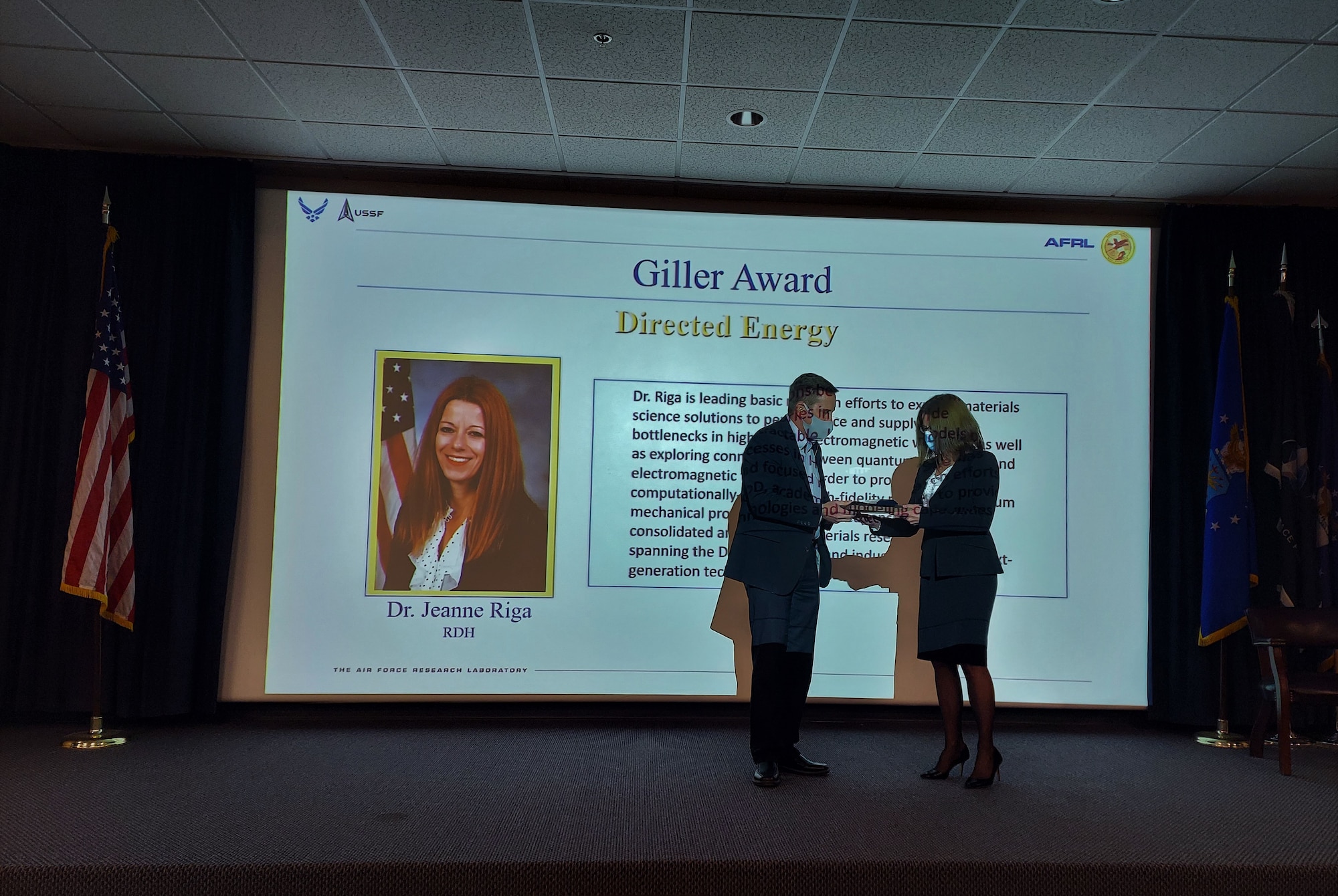 Dr. Kelly Hammett, director of the AFRL Directed Energy Directorate, presents Dr. Jeanne Riga the Giller Award for her technical advances in the field of high power electromagnetics at the unit’s 2021 Annual Awards ceremony held at Kirtland AFB, N.M. January 31. (U.S. Air Force photo/Stephanie Geeze)